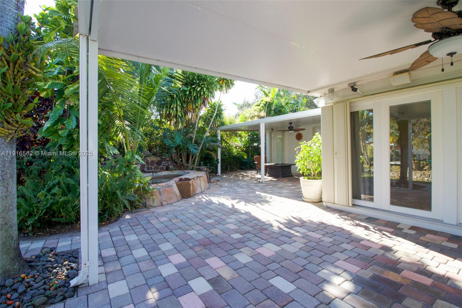 10485 Southwest 109th Street Miami, FL 33176 - Photo 42 of 45 a view of a patio with couches plants and large trees