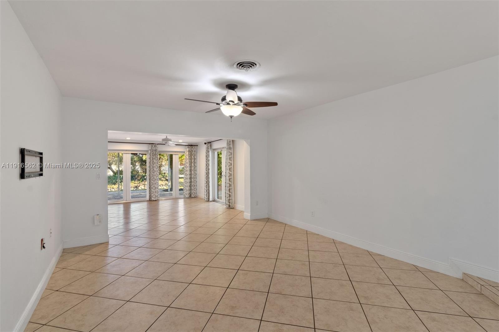 10485 Southwest 109th Street Miami, FL 33176 - Photo 7 of 45 a view of an empty room with a chandelier fan