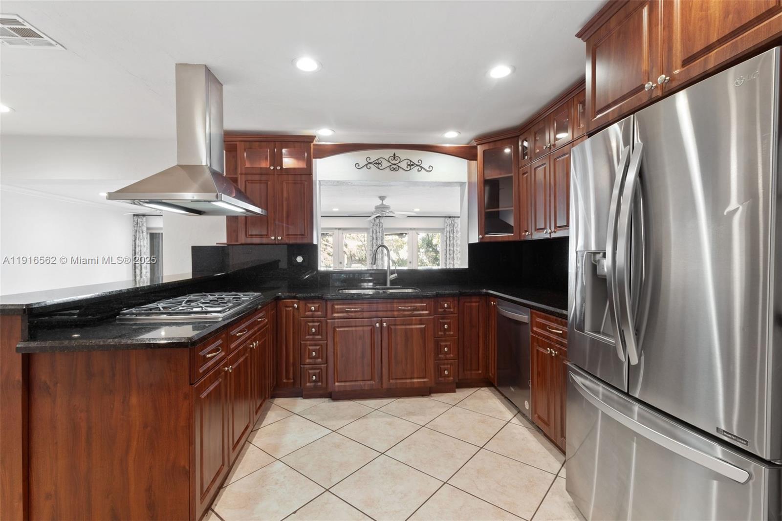 10485 Southwest 109th Street Miami, FL 33176 - Photo 10 of 45 a kitchen with stainless steel appliances granite countertop a refrigerator a stove and a sink