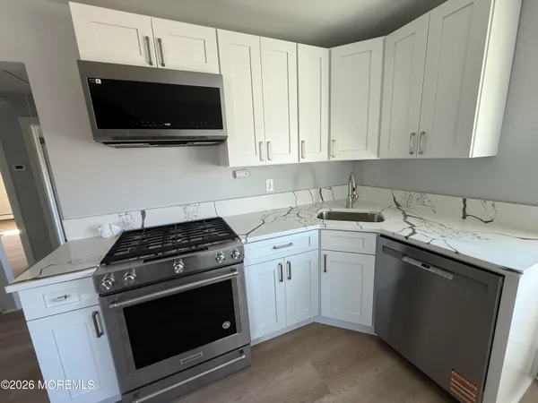 a bathroom with a shower and a sink