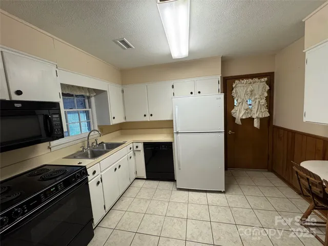 a kitchen with a stove a refrigerator and a sink