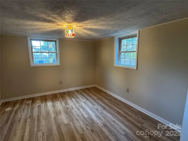 a view of room with window and hardwood floor