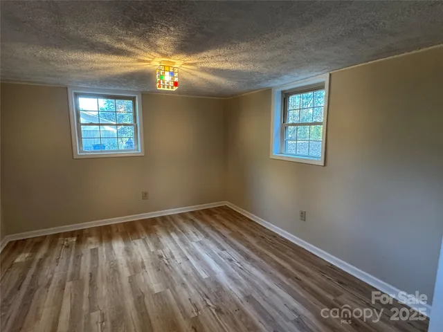 a view of room with window and hardwood floor