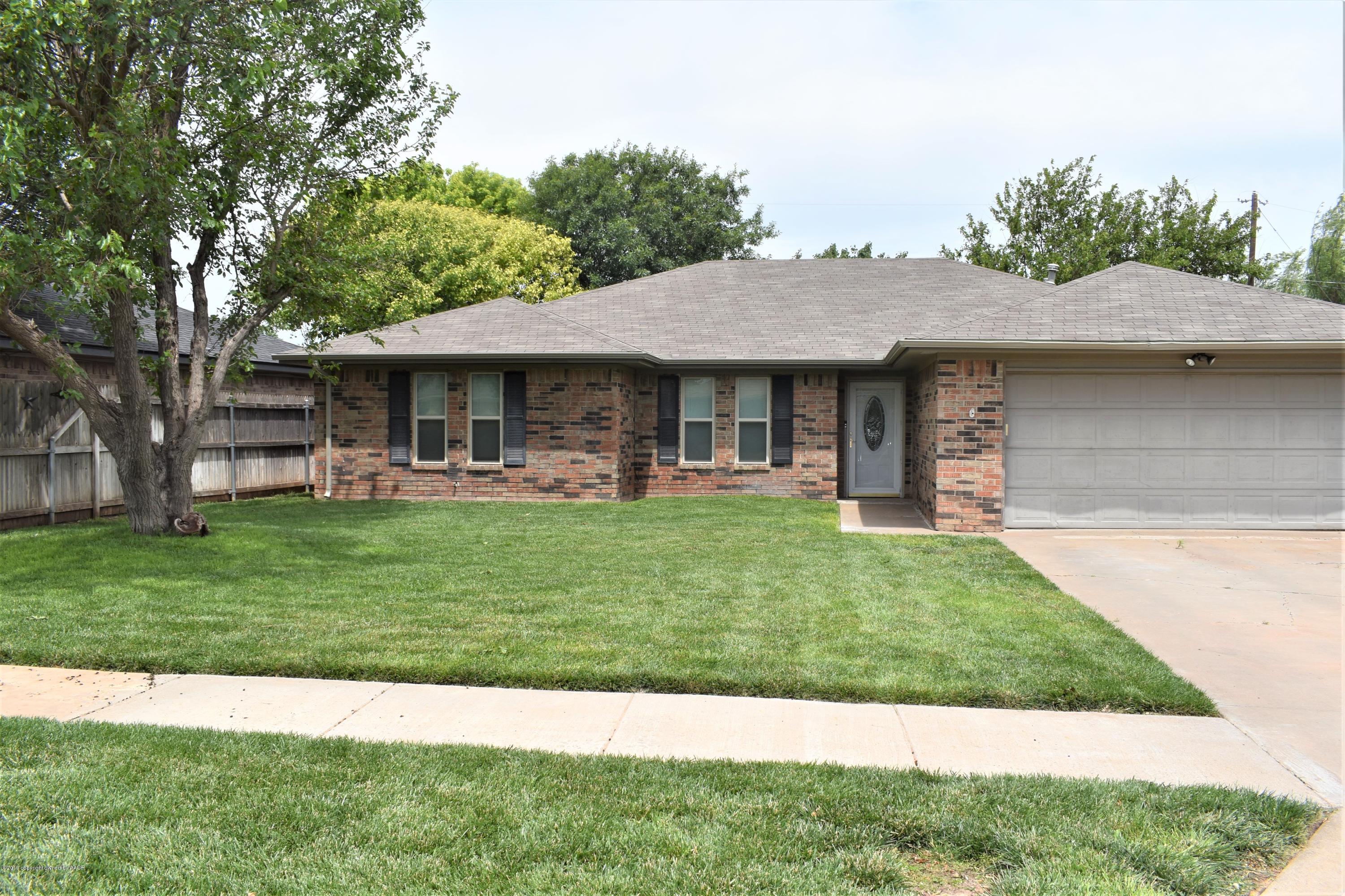 7902 Gerald Drive Amarillo, TX 79121 - Photo 1 of 17 a front view of a house with a yard table and chairs