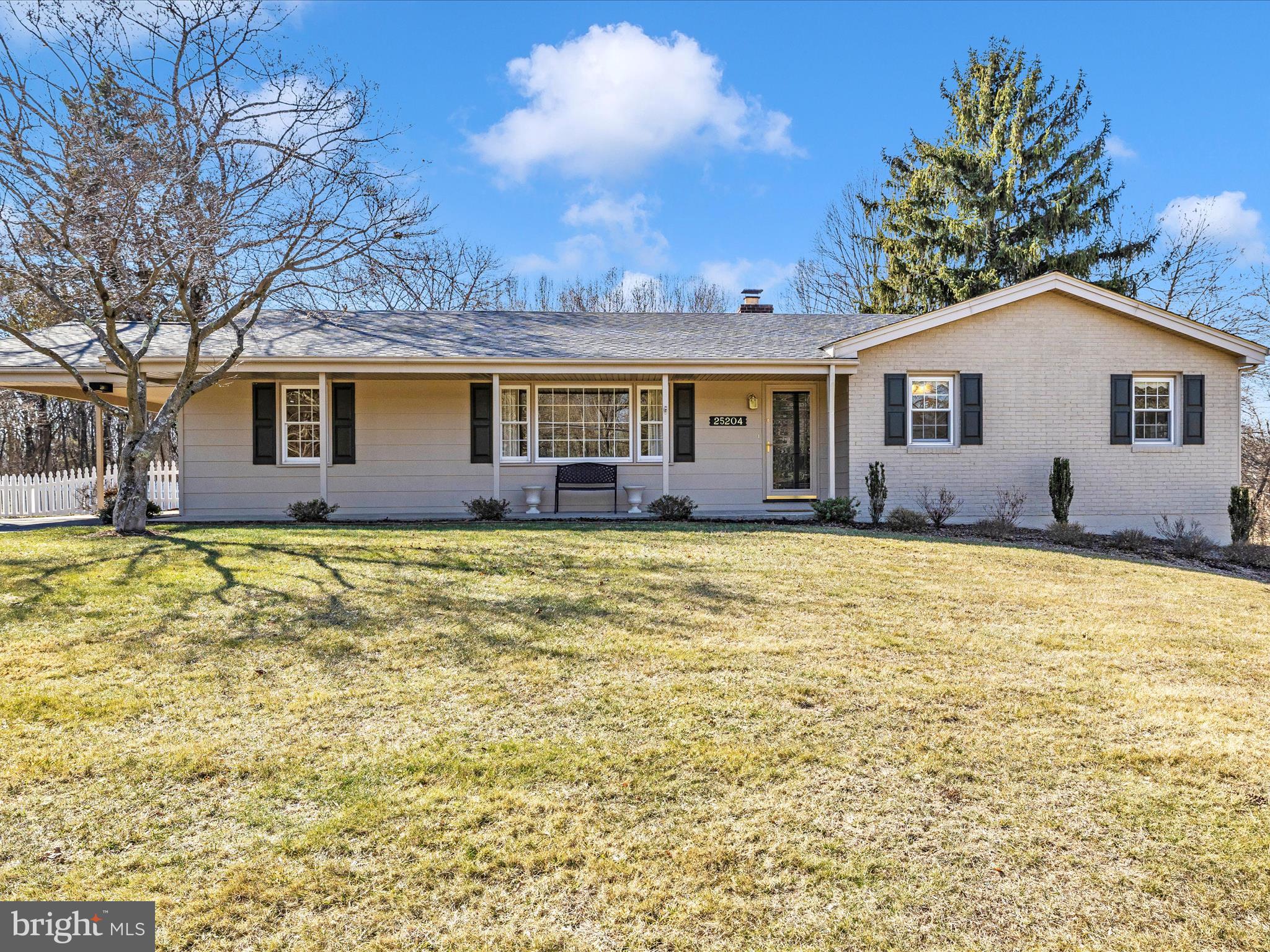 a view of house with a yard