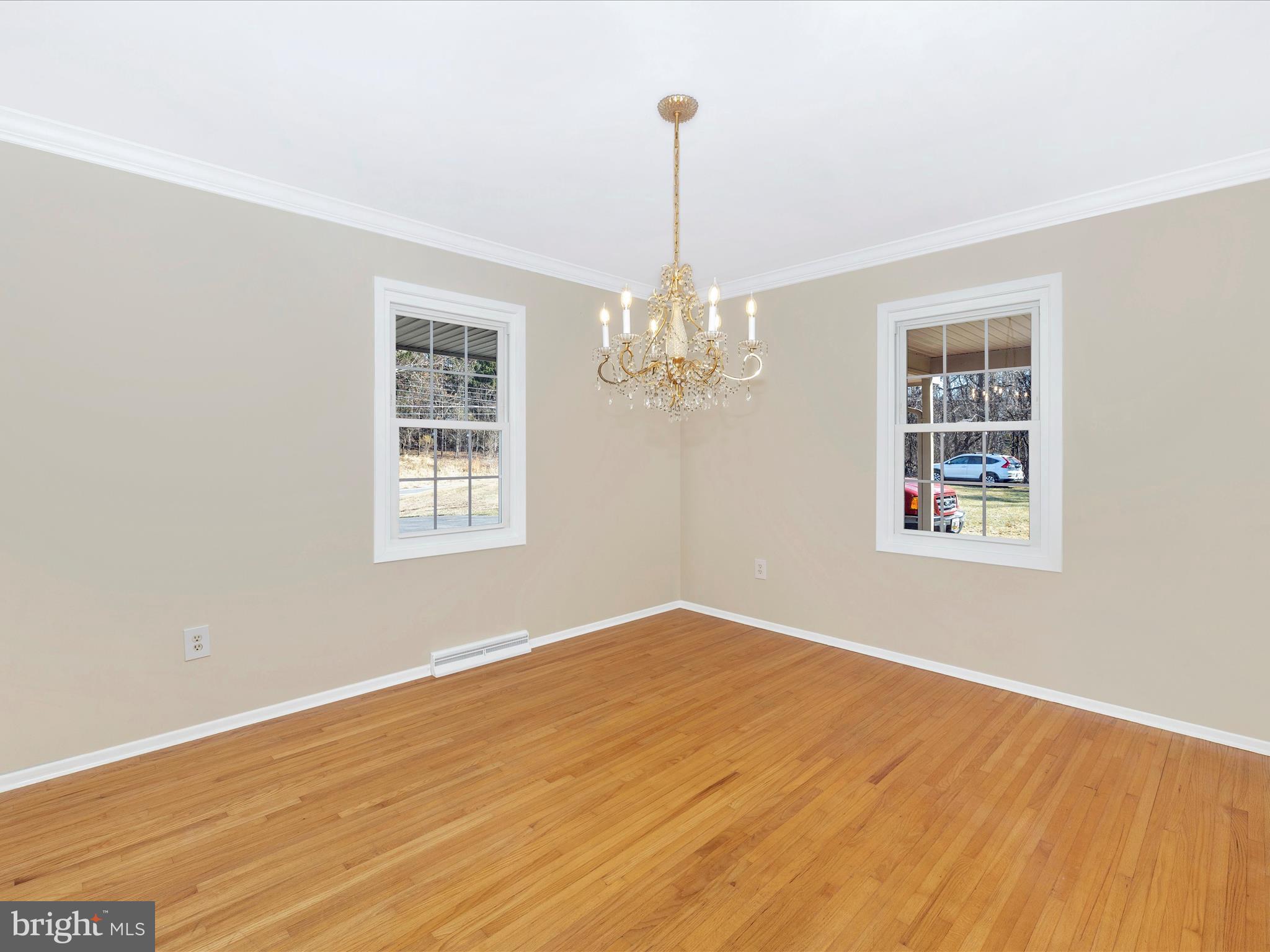 25204 Frederick Road Clarksburg, MD 20871 - Photo 11 of 58 a view of an empty room with chandelier and wooden floor