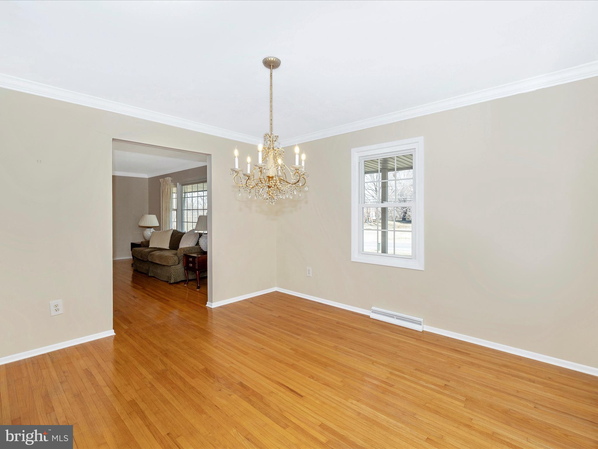 25204 Frederick Road Clarksburg, MD 20871 - Photo 12 of 58 a view of a livingroom with a furniture wooden floor and a chandelier