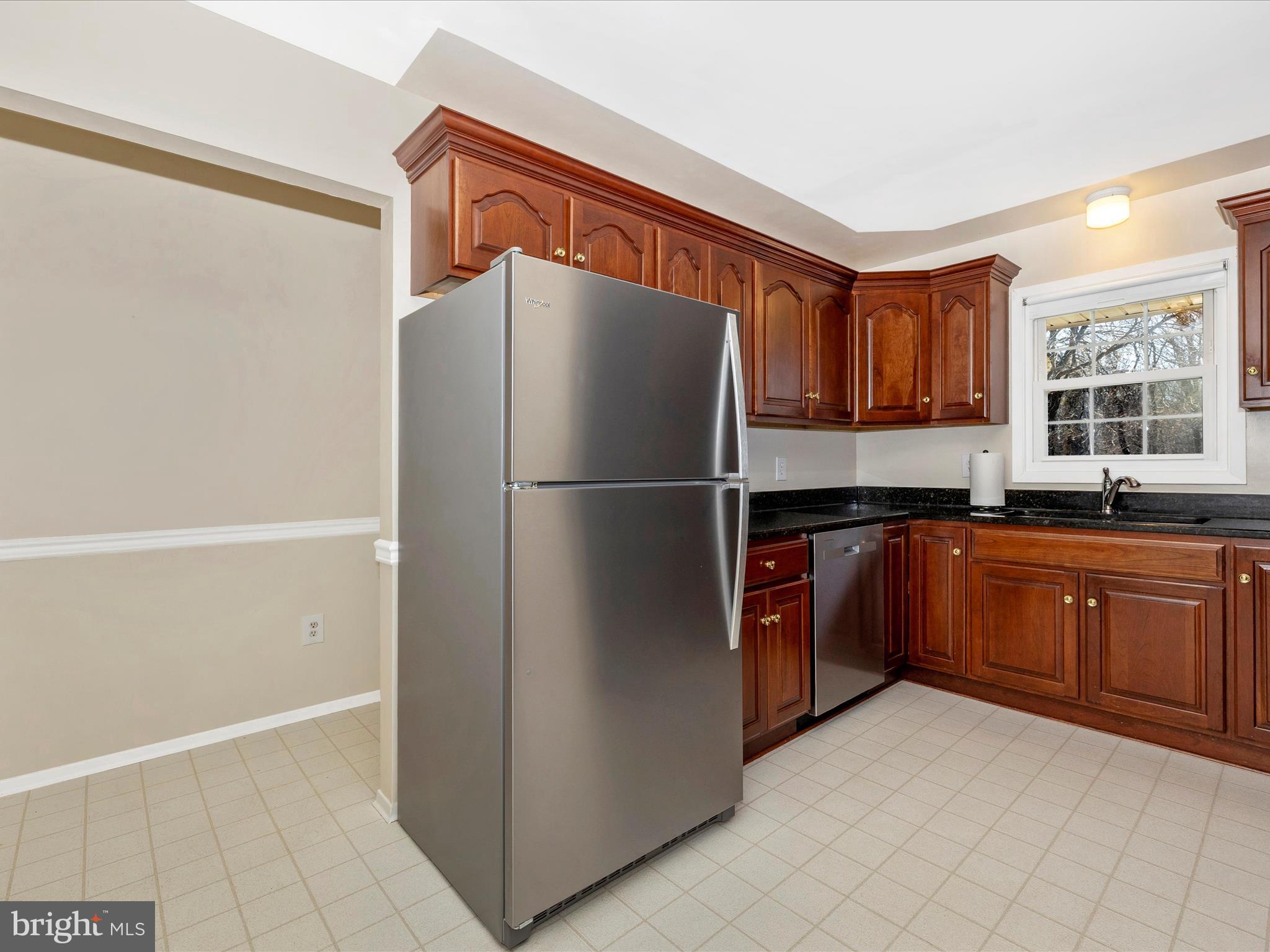 25204 Frederick Road Clarksburg, MD 20871 - Photo 14 of 58 a kitchen with stainless steel appliances granite countertop a refrigerator and a sink