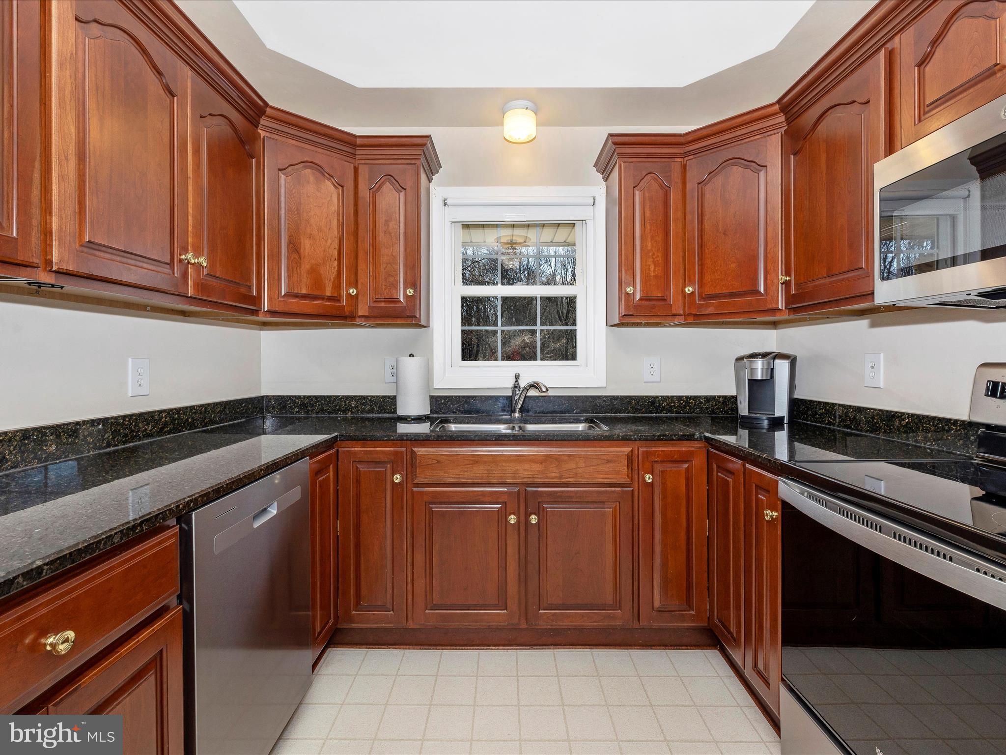 25204 Frederick Road Clarksburg, MD 20871 - Photo 16 of 58 a kitchen with stainless steel appliances granite countertop a sink stove and cabinets