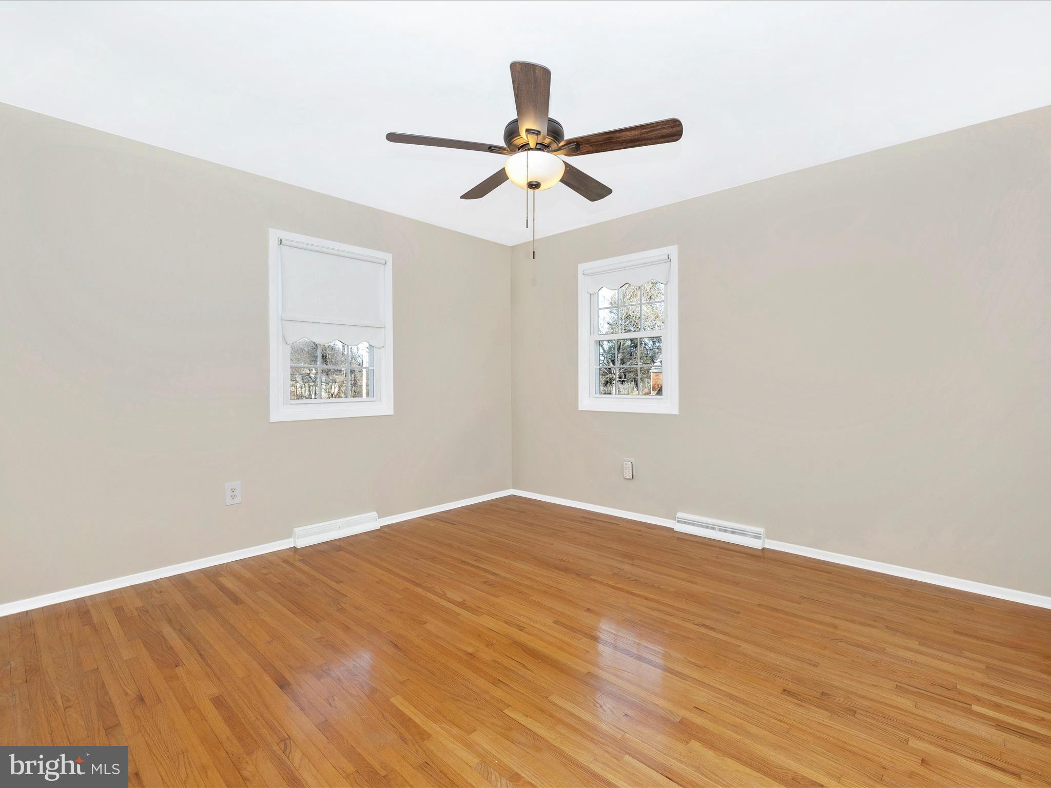 25204 Frederick Road Clarksburg, MD 20871 - Photo 24 of 58 a view of an empty room with wooden floor and a window