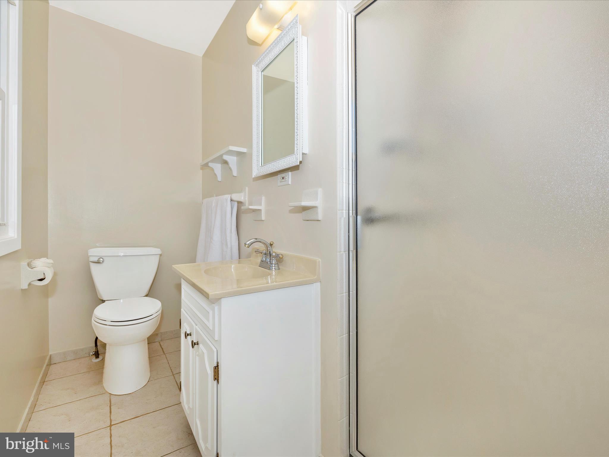 25204 Frederick Road Clarksburg, MD 20871 - Photo 28 of 58 a white toilet sitting next to a bathroom sink