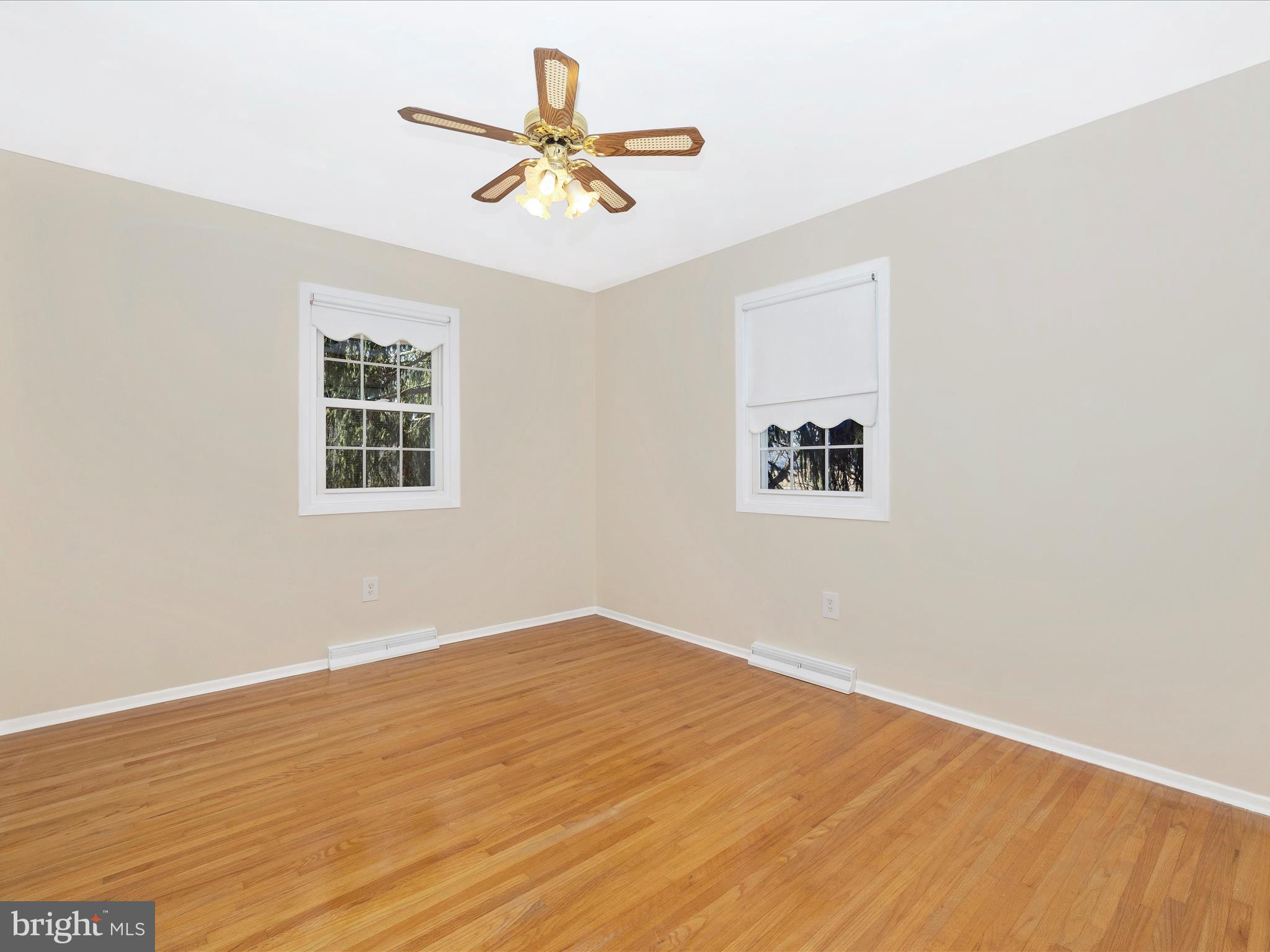 25204 Frederick Road Clarksburg, MD 20871 - Photo 29 of 58 an empty room with wooden floor and windows
