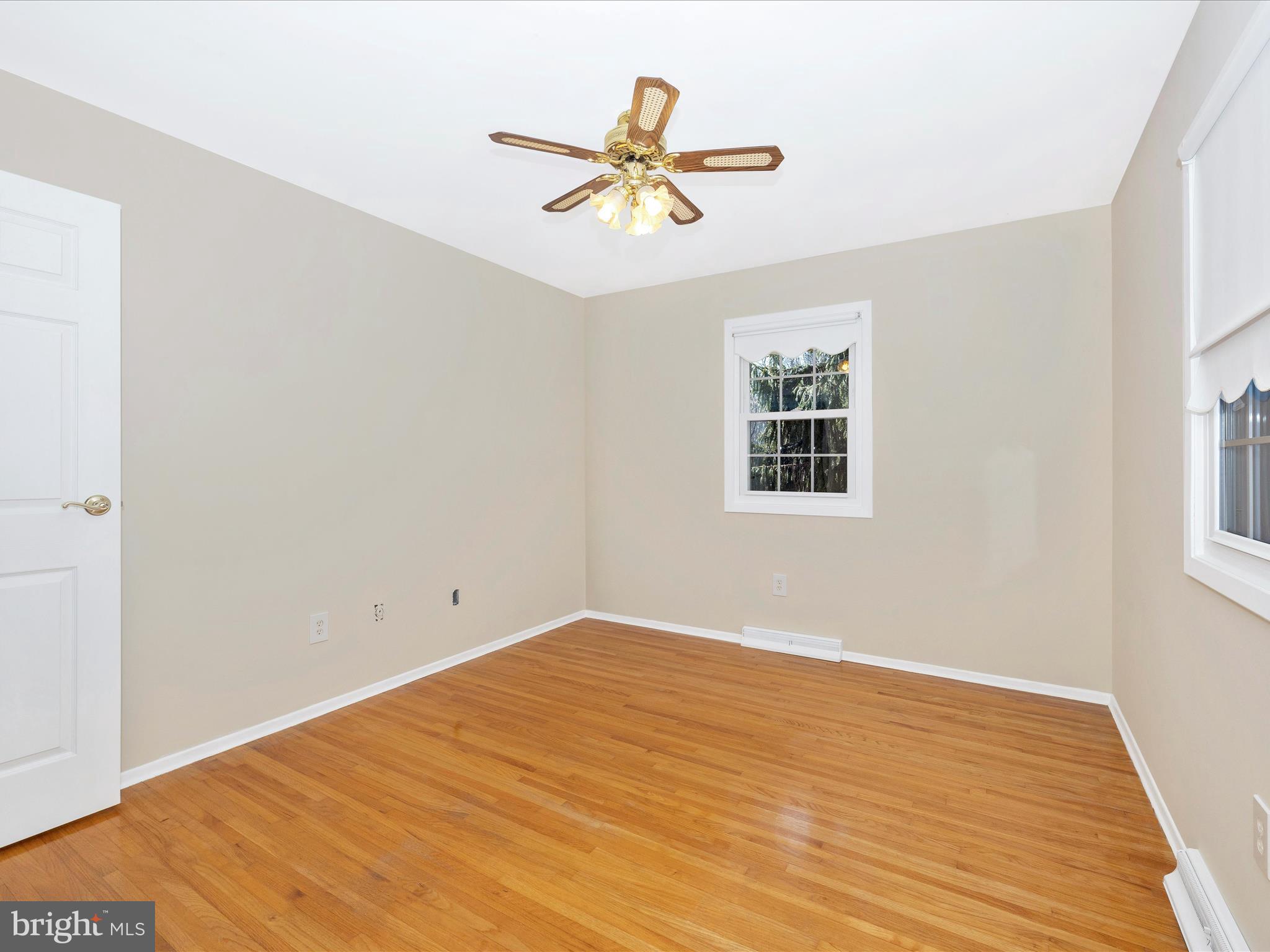 25204 Frederick Road Clarksburg, MD 20871 - Photo 30 of 58 a view of a room with wooden floor and a ceiling fan