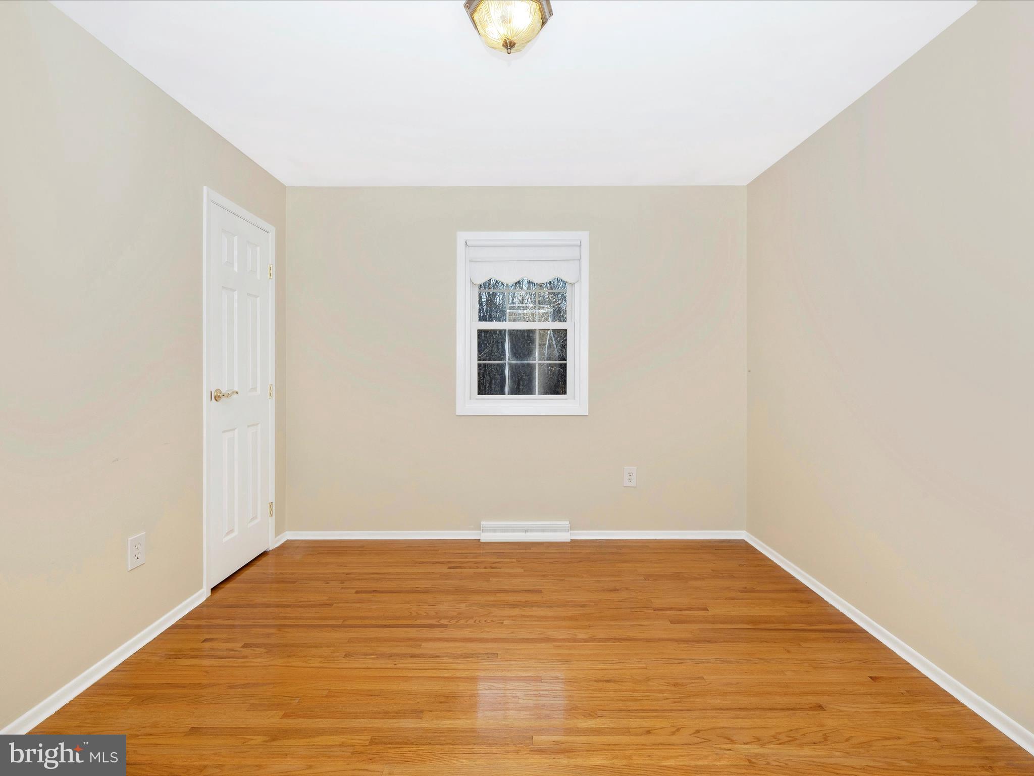 25204 Frederick Road Clarksburg, MD 20871 - Photo 33 of 58 a view of a room with wooden floor and window