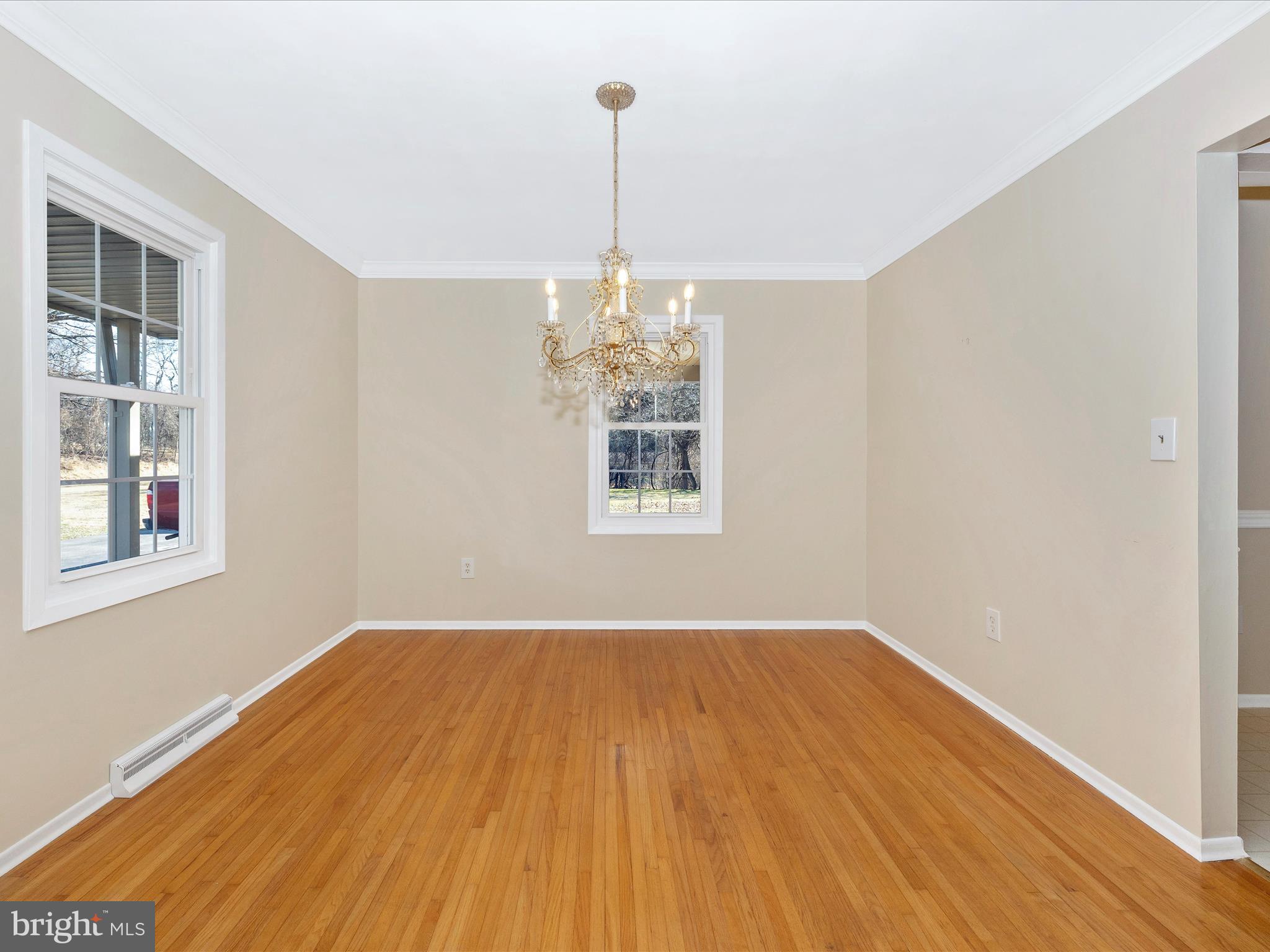 25204 Frederick Road Clarksburg, MD 20871 - Photo 10 of 58 a view of a room with wooden floor chandeliers and kitchen view
