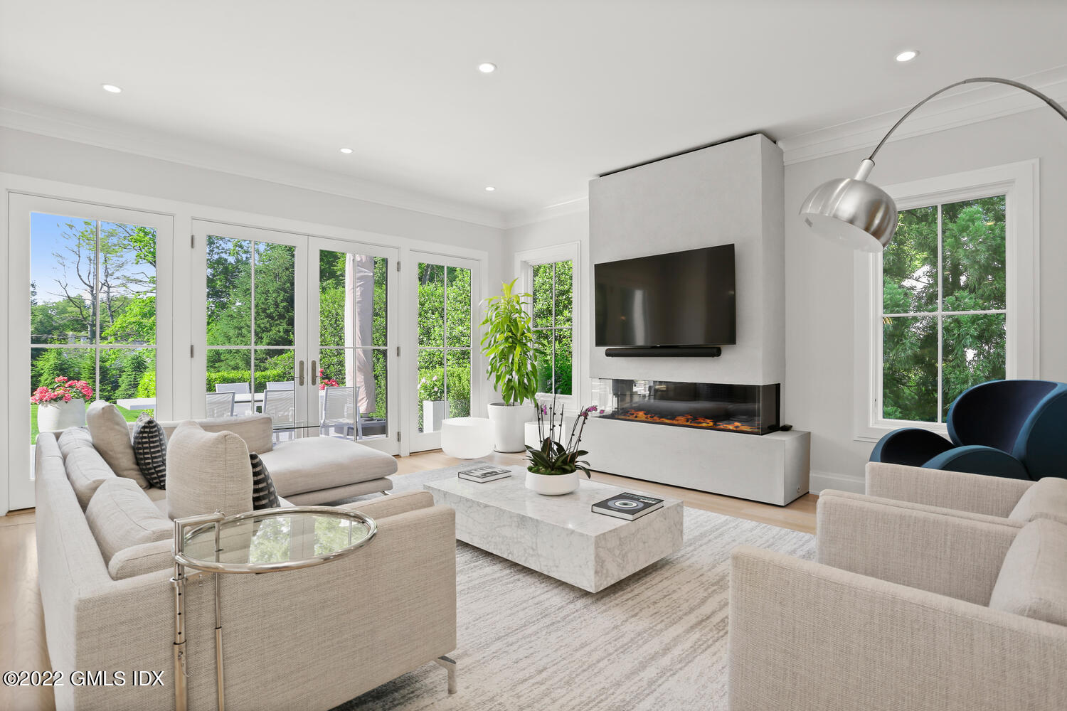 11 Turner Drive Greenwich, CT 06831 - Photo 11 of 35 a living room with furniture a large window and a flat screen tv