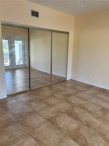 an empty room with windows and entrance