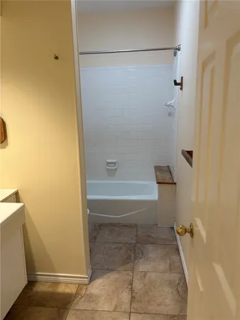 a bathroom with a granite countertop shower and a toilet
