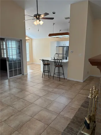 a view of a livingroom with furniture and a ceiling fan