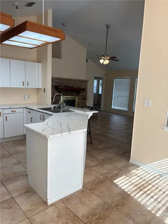 a kitchen with stainless steel appliances granite countertop a sink a stove and a refrigerator