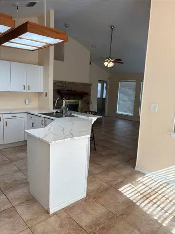 a kitchen with stainless steel appliances granite countertop a sink a stove and a refrigerator