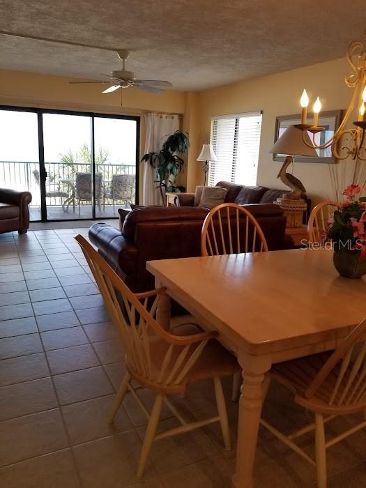 13650 Gulf Boulevard, Unit 304 Madeira Beach, FL 33708 - Photo 31 of 63 a view of a dining room with furniture and a large window
