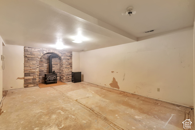 386 North 210 East Mapleton, UT 84664 - Photo 23 of 30 Arched stone-face fireplace with a freestanding wood-burning stove
