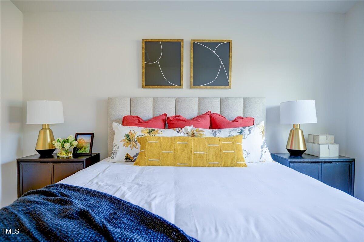2208 Fletchers Ridge Drive Durham, NC 27703 - Photo 24 of 26 a bedroom with a bed and dresser