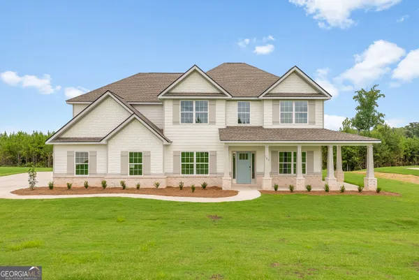 a front view of house with yard patio and green space