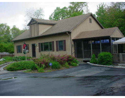 97 Howland Road Freetown, MA 02702 - Photo 1 of 6 a front view of a house with a garden