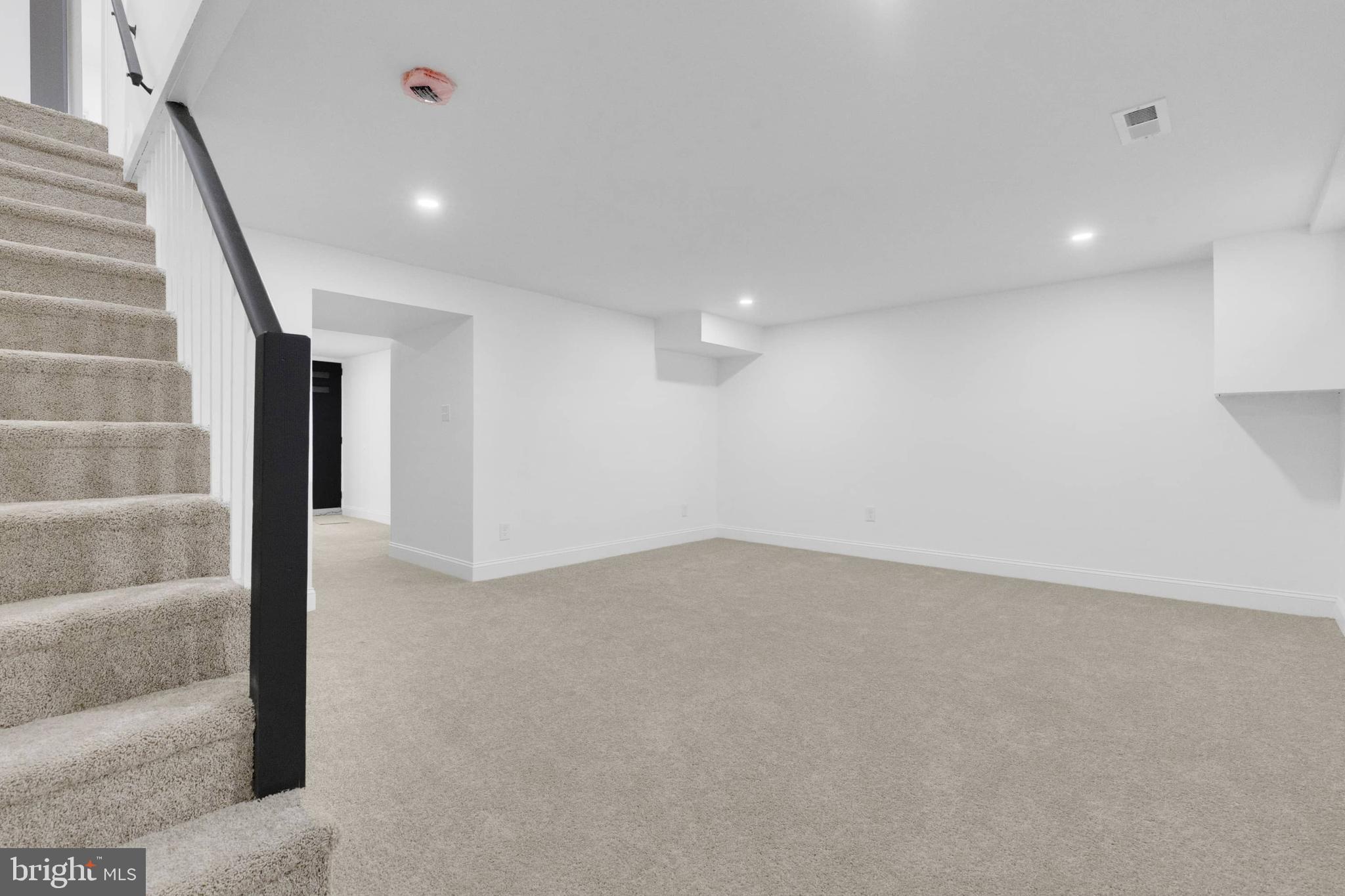 1403 Stonewood Road Baltimore, MD 21239 - Photo 19 of 36 a view of an empty room with a staircase