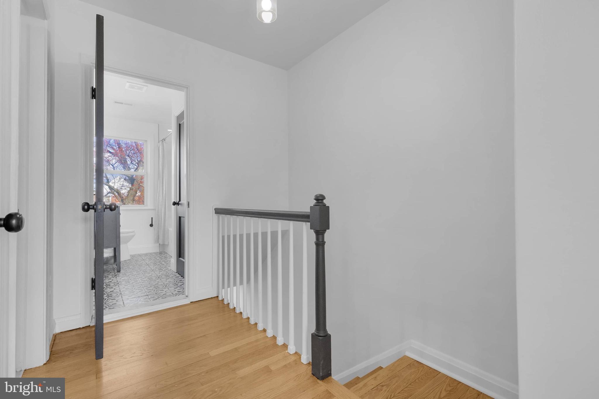 1403 Stonewood Road Baltimore, MD 21239 - Photo 29 of 36 a view of a hallway with wooden floor