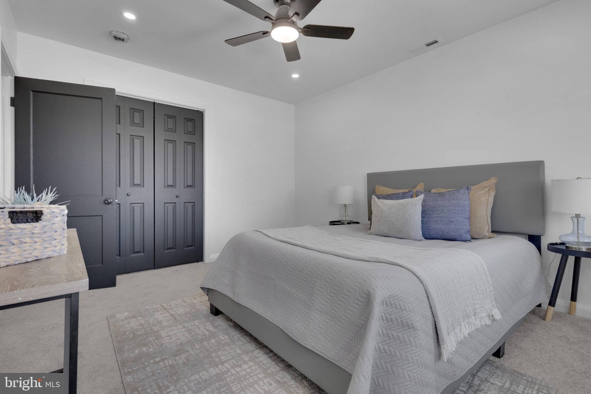 1403 Stonewood Road Baltimore, MD 21239 - Photo 30 of 36 a bedroom with a bed and a chandelier