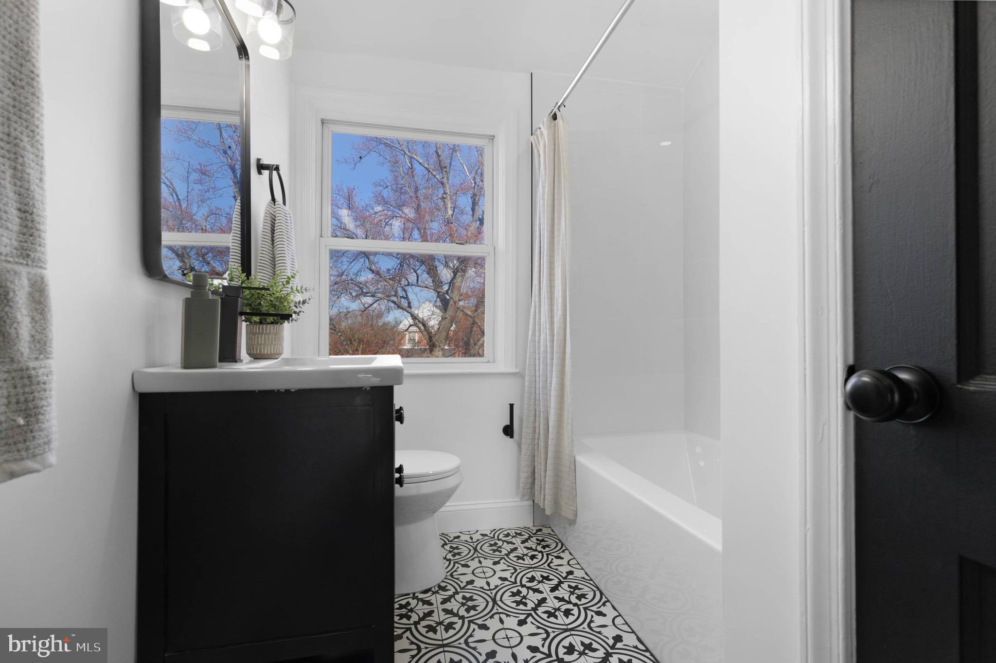 1403 Stonewood Road Baltimore, MD 21239 - Photo 32 of 36 a bathroom with a bathtub sink and toilet