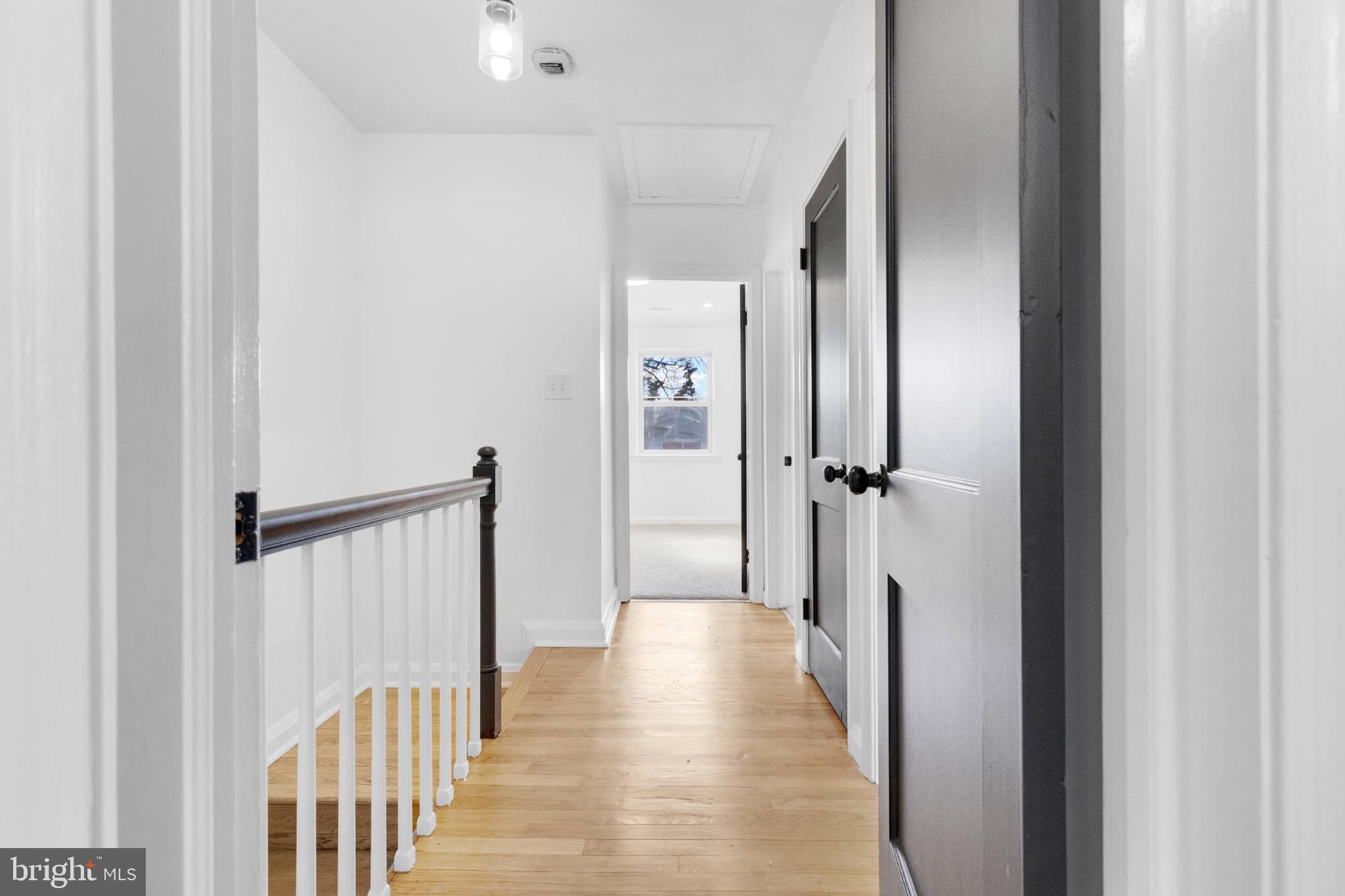 1403 Stonewood Road Baltimore, MD 21239 - Photo 33 of 36 a view of a hallway with wooden floor and staircase