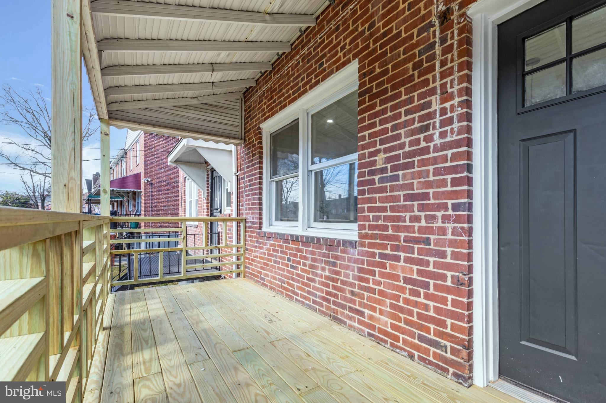 1403 Stonewood Road Baltimore, MD 21239 - Photo 35 of 36 a view of a brick house with an outdoor space