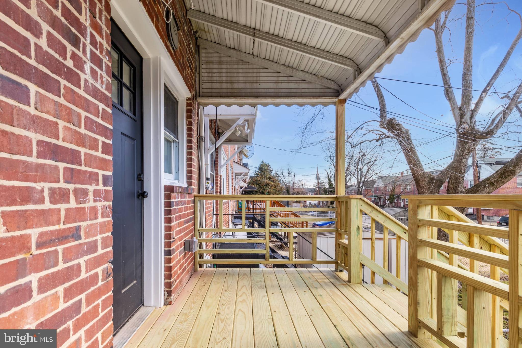 1403 Stonewood Road Baltimore, MD 21239 - Photo 36 of 36 a view of balcony with wooden floor and seating space