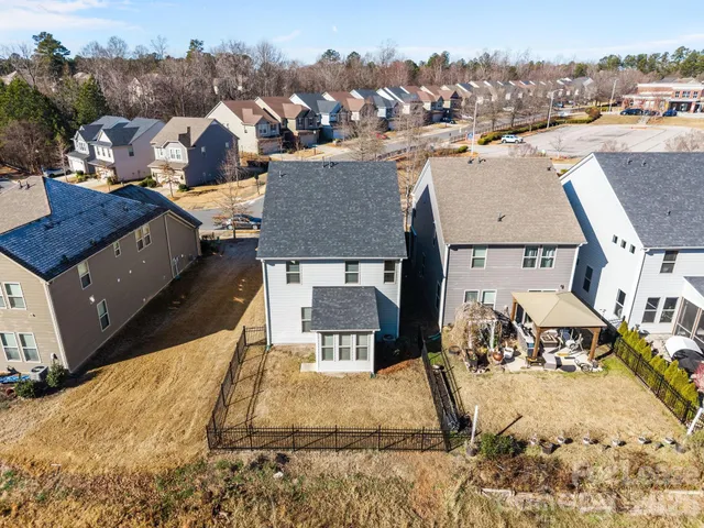 an aerial view of a residential houses with outdoor space