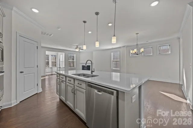 a kitchen with stainless steel appliances granite countertop a sink a oven and a refrigerator