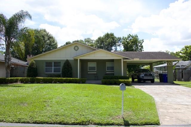 a front view of house with yard and green space