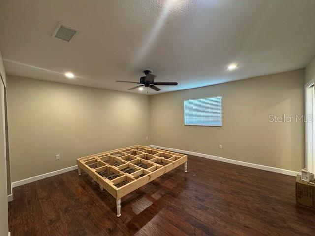 4825 Kimball Court East Lakeland, FL 33813 - Photo 17 of 26 a view of a room with a ceiling fan and wooden floor
