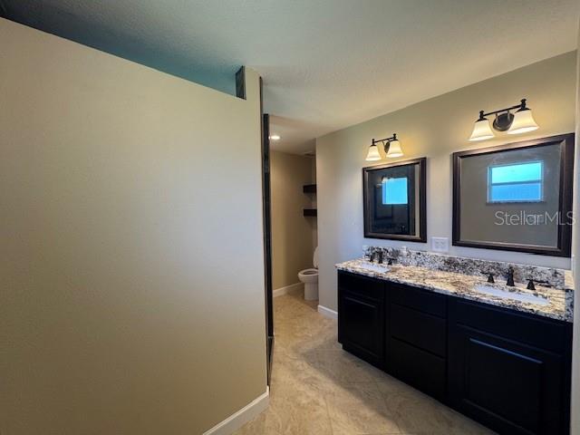 4825 Kimball Court East Lakeland, FL 33813 - Photo 19 of 26 a bathroom with a double vanity sink and a mirror