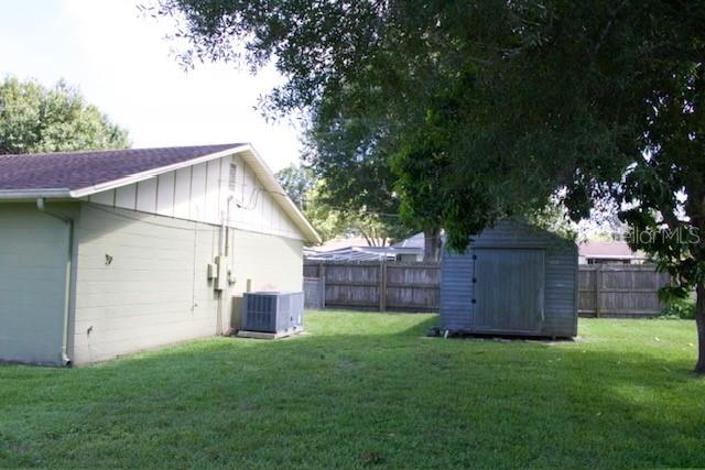 4825 Kimball Court East Lakeland, FL 33813 - Photo 26 of 26 a view of a backyard with a small cabin and wooden fence