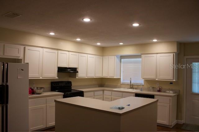 4825 Kimball Court East Lakeland, FL 33813 - Photo 5 of 26 a kitchen that has a sink and a refrigerator in it