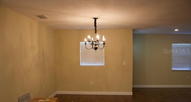 4825 Kimball Court East Lakeland, FL 33813 - Photo 7 of 26 a room with window and a chandelier