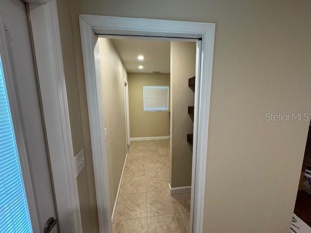 4825 Kimball Court East Lakeland, FL 33813 - Photo 9 of 26 a view of a bathroom from a corridor
