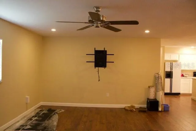 a room with a window and a ceiling fan