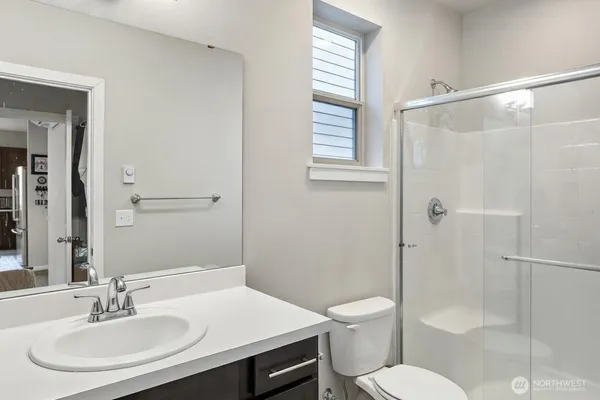 a bathroom with a sink toilet and shower