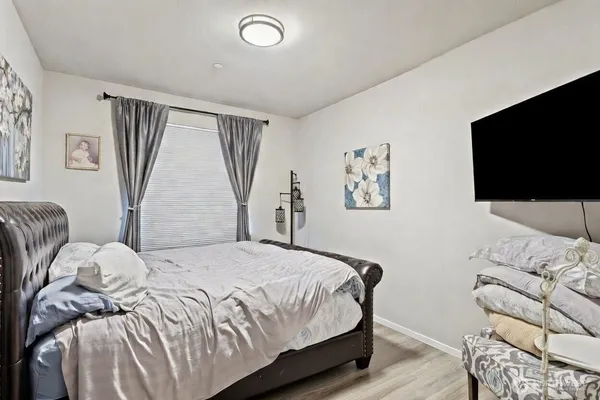 a bedroom with a bed and a flat screen tv