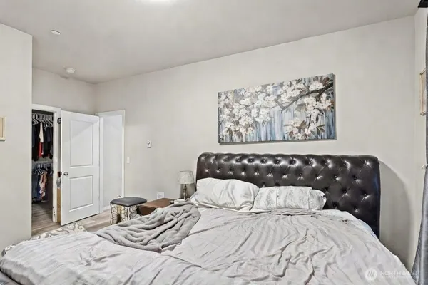 a bedroom with a bed and wall painting